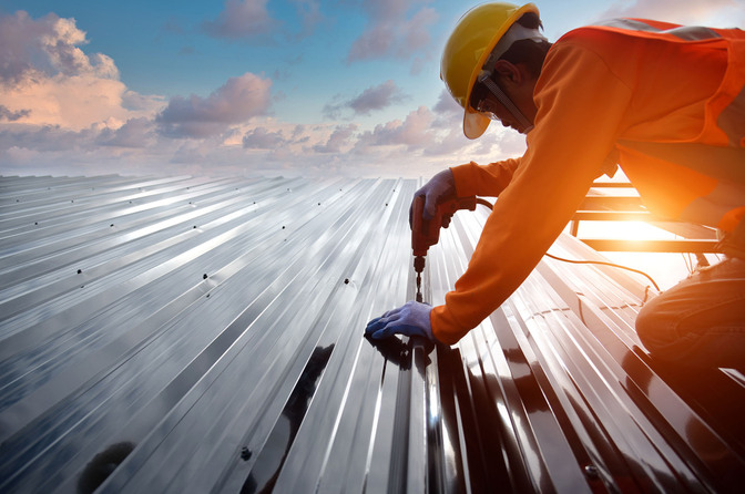 Commercial roofer working on a reflective roof